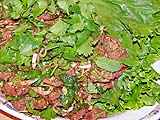Grilled beef salad garnished with mint and cilantro