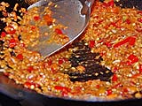 Stir-frying garlic, chillies and shrimp paste