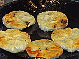 Crisping the stuffed chive cakes after steaming